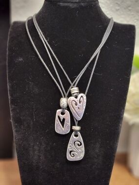 Brighton Brazilian Multi Charm Necklace features a triple-strand black cord 19"